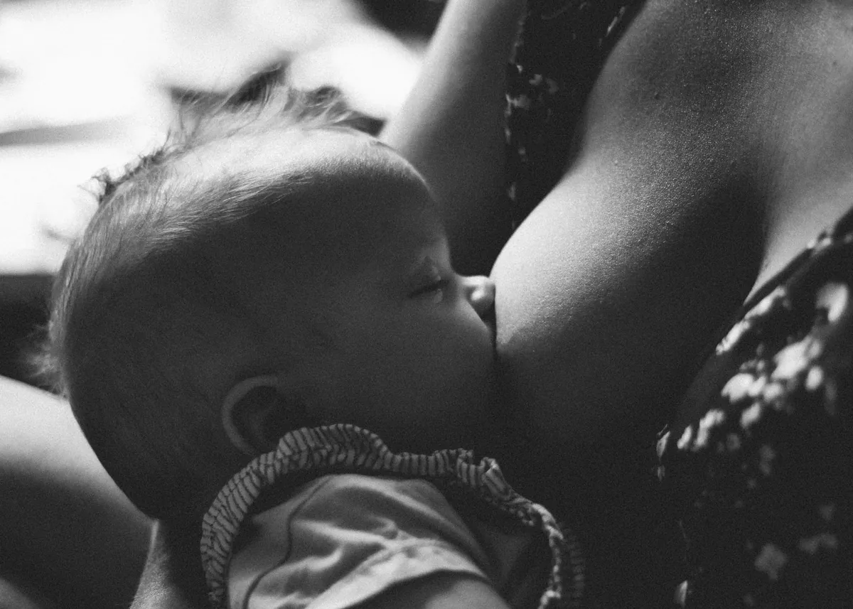 baby breastfeeding black and white